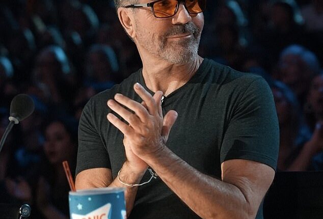 Simon Cowell has revealed why he is often seen wearing red-tinted glasses while filming