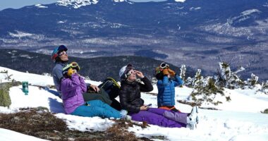 A family watches the solar eclipse from Saddleback Mountain in Rangeley, Maine, on Monday April 8th, in one of the last viewings of the day