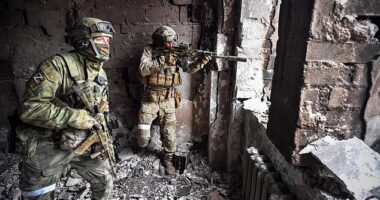 Pictured: Russian soldiers at the Mariupol drama theatre which was hit by an airstrike on March 26.  Brave citizens such as Andrii are sending photos of documents and buildings to the Ukrainian army