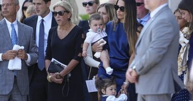 The wife of NHL star Johnny Gaudreau, Meredith (in blue) was seen holding her daughter and son outside of St. Mary Magdalen Catholic Church in Media, Pennsylvania Monday