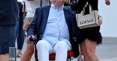 Eamonn Holmes patting her bottom as they head out for a night in Ibiza.