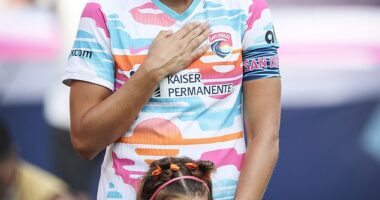 Alex Morgan stood beside her daughter, Charlie, for the final match of her professional career