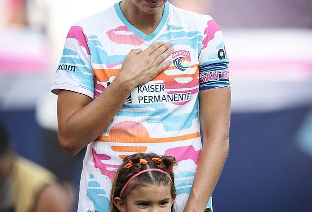 Alex Morgan stood beside her daughter, Charlie, for the final match of her professional career