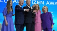 President Joe Biden and first lady Jill Biden pose for a photo after he was presented with the Global Citizen Award by former President Bill Clinton, Chelsea Clinton and former Secretary of State Hillary Clinton at the Clinton Global Initiative