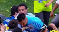 A Boca fan puts his left hand on the chest of goalkeeper Romero after losing to River Plate
