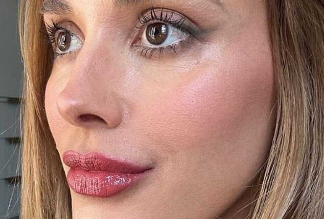 Bec Judd, 41, shows off her glowing and completely wrinkle-free skin  in a well-lit close up shot