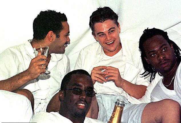 Leonardo DiCaprio (back center) and Diddy (front center) party with friends