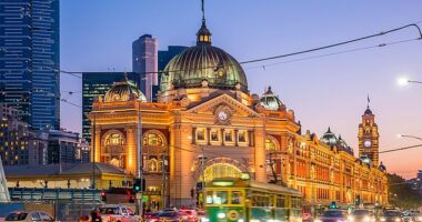 Melbourne house prices have fallen during the past year despite record-high immigration levels, new figures show (pictured is Flinders Street Station)