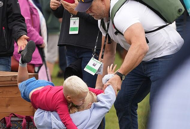 Mike Tindall was forced to break up a harmless play fight between his two youngest children as they arrived to cheer on Zara at the Burghley Horse Trials today