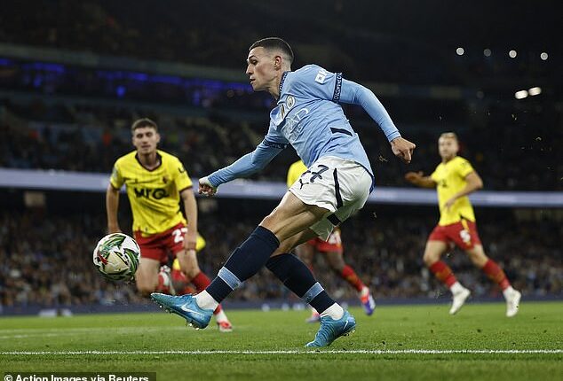 Phil Foden (centre) pictured in action for Man City during Tuesday night's 2-1 win over Watford