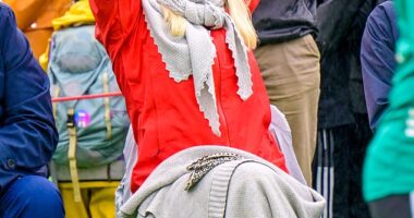 Mette-Marit looked in high spirits as she cheered on a school football game in the rain today