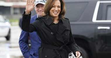 Democratic presidential nominee and Vice President Kamala Harris waves after being greeted by Senator Mark Kelly, D-Ariz., as she departs for the U.S.-Mexico border from D.C.