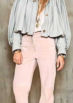 Sienna Miller looked effortlessly chic in a floaty jacket and suede trousers at the Chloe show for Paris Fashion Week on Thursday