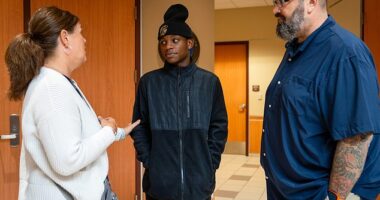 From left, a supporter and former teacher, Elijah Goldman and Scott Lama talk following a hearing concerning the custody of Elijah at the Robert T. Griffin Hall of Justice in Traverse City on Wednesday, Sept. 11, 2024