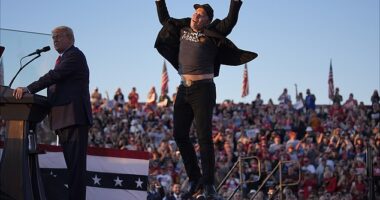 Elon Musk jumps on the stage as Republican presidential nominee former President Donald Trump speaks at a campaign rally at the Butler Farm Show, Saturday, Oct. 5, 2024, in Butler, Pa