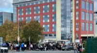 Police cordon off roads and passengers wait with their luggage as Birmingham Airport is evacuated