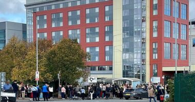 Police cordon off roads and passengers wait with their luggage as Birmingham Airport is evacuated