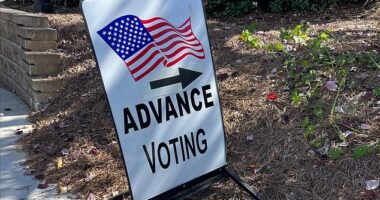 An early voting sign directing people where to go to cast a ballot at a polling location before Election Day in Georgia. A record number of people are participating in early voting in the battleground state