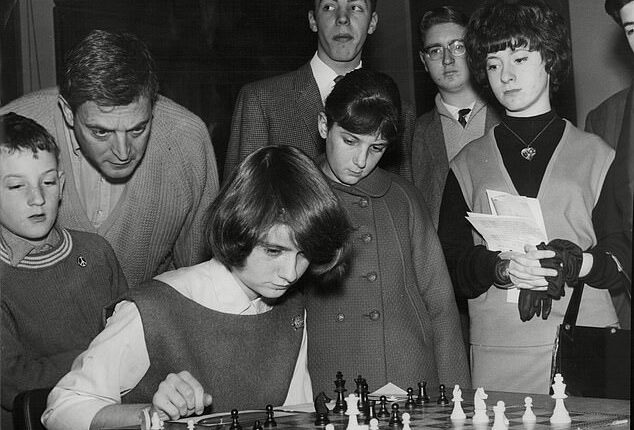 Paul Keres, in the middle looking down at the board, contested the title in a tournament split between The Hague in the Netherlands and Moscow