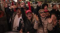 Supporters of Republican presidential nominee former President Donald Trump react as Elon Musk takes stage during a campaign rally at Madison Square Garden, Sunday in New York