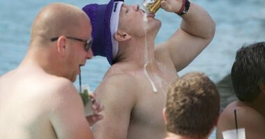 Mike Tindall guzzling a can of beer in the pool during his stag do in Miami in June 2011