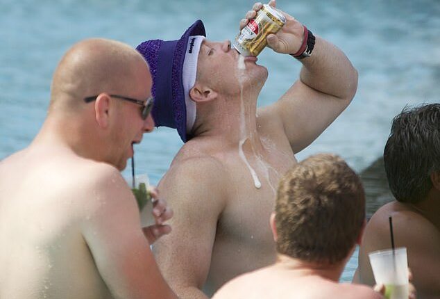 Mike Tindall guzzling a can of beer in the pool during his stag do in Miami in June 2011