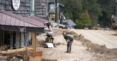 A member of law enforcement surveys flood damage in the aftermath of Hurricane Helene on October 2, 2024 in Chimney Rock, North Carolina. The death toll has topped 180 people across the southeastern U.S. due to the storm, according to published reports, which made landfall as a category 4 storm last Thursday. Mayorkas says FEMA is running out of money to help
