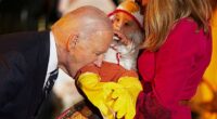 Joe Biden playfully bites a baby during trick-or-treating at the White House