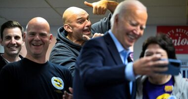 Pennsylvania Sen. John Fetterman (center) photobombed a selfie President Joe Biden (second from right) was taking with a phone-banking volunteer Saturday at Steamfitters Technology Center in Pittsburgh