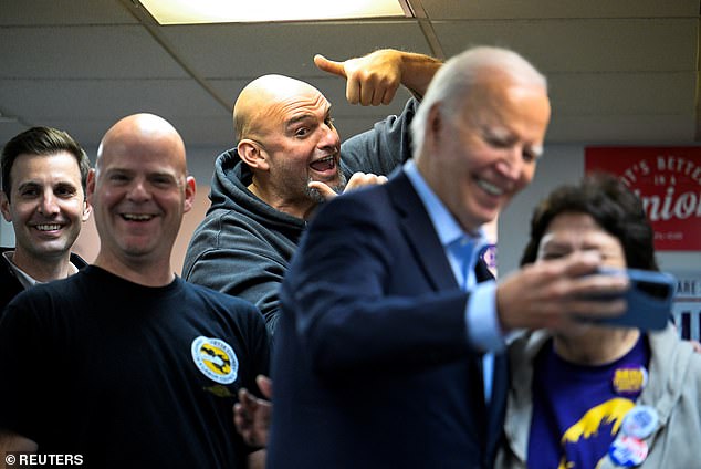 Pennsylvania Sen. John Fetterman (center) photobombed a selfie President Joe Biden (second from right) was taking with a phone-banking volunteer Saturday at Steamfitters Technology Center in Pittsburgh