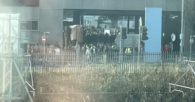 Pictured: Passengers and staff being evacuated from Birmingham Airport this afternoon as police deal with an ongoing incident