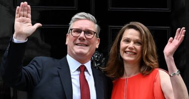 Prime Minister Keir Starmer and his wife Victoria wave as they pose on the steps of 10 Downing Street in London on July 5