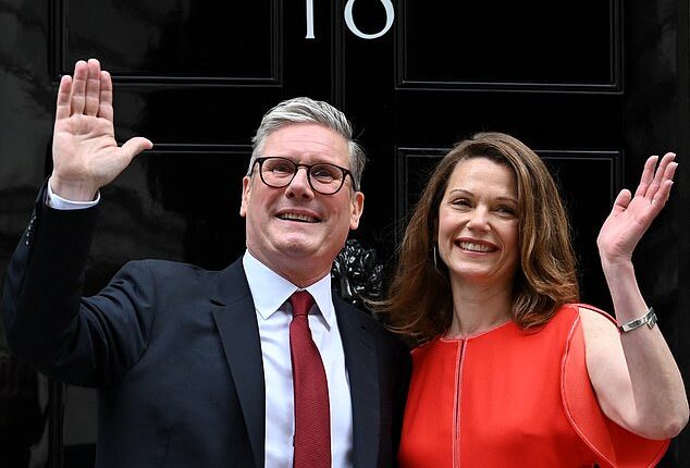 Prime Minister Keir Starmer and his wife Victoria wave as they pose on the steps of 10 Downing Street in London on July 5