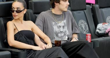 Cruz Beckham appeared smitten with his girlfriend Jackie Apostel as they pair stepped out to support his football club owner dad David in Florida on Saturday