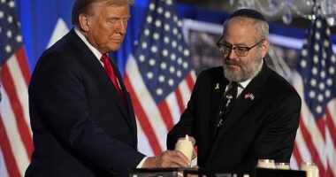 Republican presidential nominee former President Donald Trump lights a candle with Rabbi Yeshuda Kaploun at an event marking one year since the Oct. 7 Hamas attack on Israel, Monday, Oct. 7, 2024, in Miami
