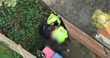 Police officers hunt down a suspect following a 70mph chase through residential streets on Wednesday
