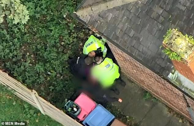 Police officers hunt down a suspect following a 70mph chase through residential streets on Wednesday