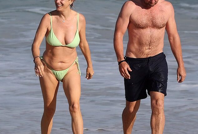 Kate Walsh appears to be loving her life Down Under as she hit the beach in Perth with her fiancé Andrew Nixon on Thursday