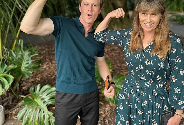 Robert Irwin whipped his female fans into a frenzy on Tuesday after he shared a gallery of jaw-dropping photos to social media. Pictured: Robert and Terri Irwin