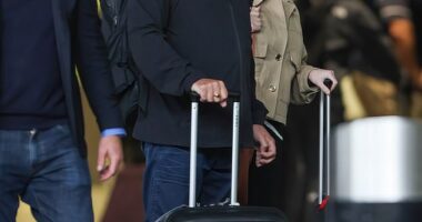Gregg Wallace kept a low-key figure under a black baseball cap as he landed in the UK with wife Anne-Marie Sterpini on Monday after a four-day getaway to Italy