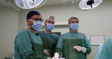 three doctors in an operating room