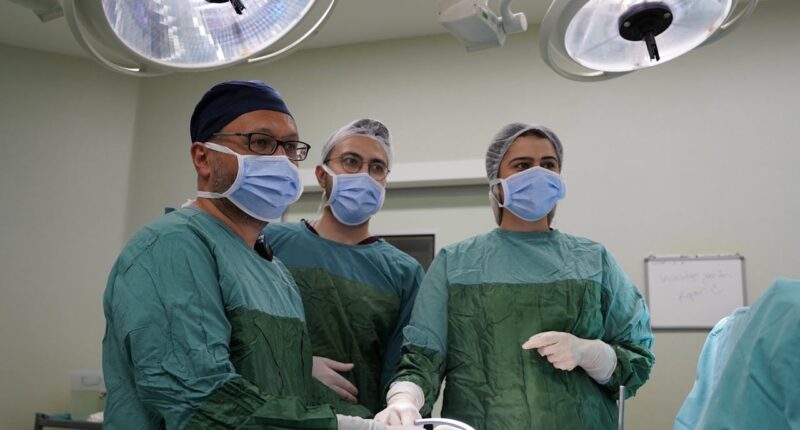 three doctors in an operating room