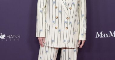 Kate Winslet looked ultra chic in a white pinstripe suit boasting an elegant blue floral pattern