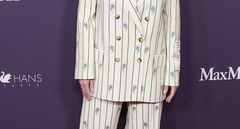 Kate Winslet looked ultra chic in a white pinstripe suit boasting an elegant blue floral pattern