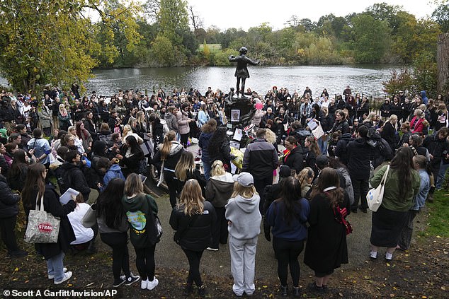 A large crowd gathers in Hyde Park, London, today at the Peter Pan statue, to honour the former One Direction star