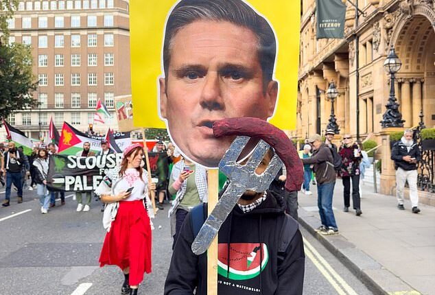One protester held a placard mocking Sir Keir Starmer after his fumble during his speech at a Labour conference where he called for 'immediate ceasefire' in Gaza and 'a return of the sausages' when discussing the ongoing war between Israel and Hamas'