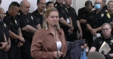 Moment dozens of Honolulu cops turnout to block $1.5m payout to widow of sports star killed by officer