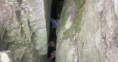 The woman became wedged upside down after she slipped down a three-metre crevice between two boulders