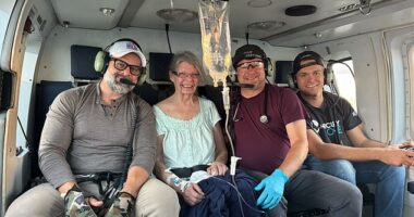 Rep. Cory Mills, R-Fla., (L) sits next to a smiling woman helped during his Hurricane Helene relief efforts in North Carolina. The woman was unable to get help and showing signs of illness, Mills said