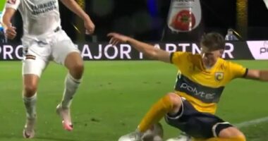 Mariners defender Lucas Mauragis (right) about to 'introduce' himself to Melbourne Victory coach Patrick Kisnorbo